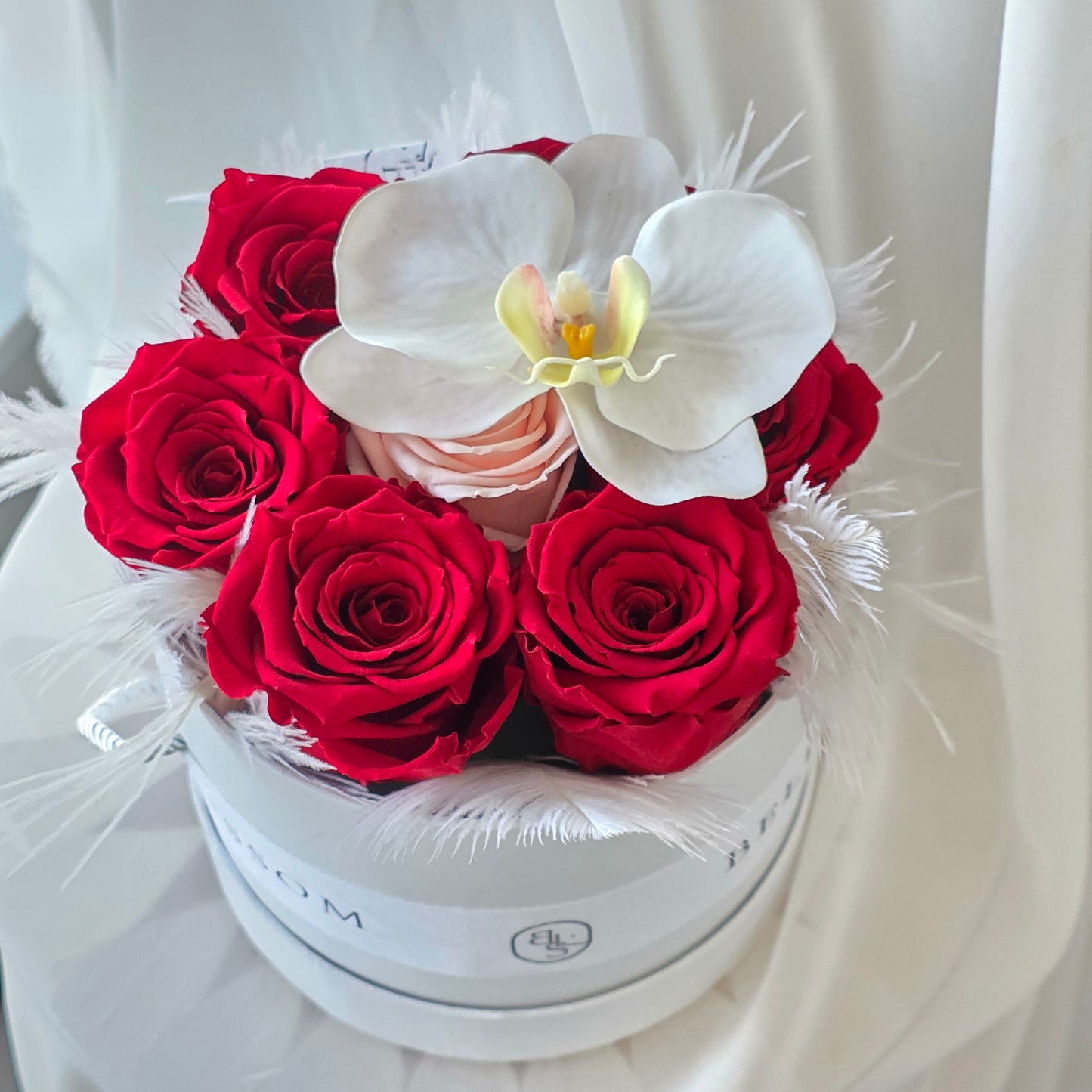 Close up of preserved roses and orchid petals in floral box