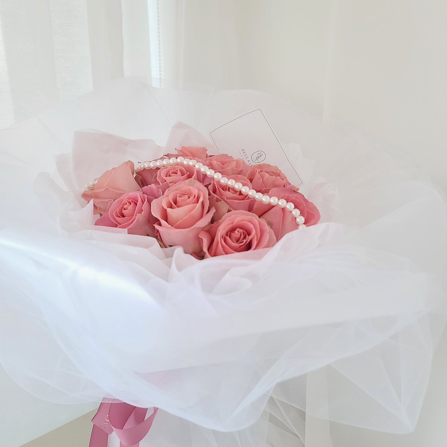 Close-up of 12-rose Be My Valentine Bouquet with fairy-tale shiffon wrap and pearl detail, delivery across Vancouver or Metrotown pick-up