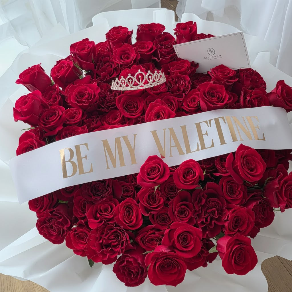 Exclusive Bellassom 100-rose Valentine's Day arrangement with custom printed sash and logo ribbon.
