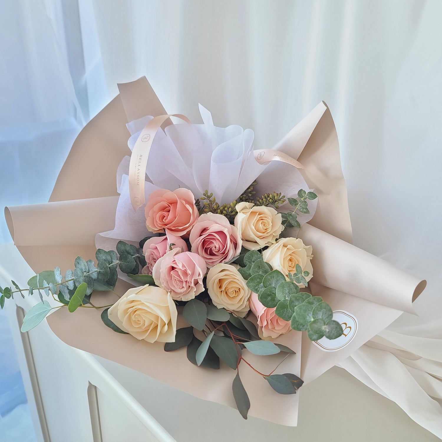Elegant rose and eucalyptus arrangement wrapped in Bellassom’s signature style, delivery across Vancouver or pick-up from Metrotown