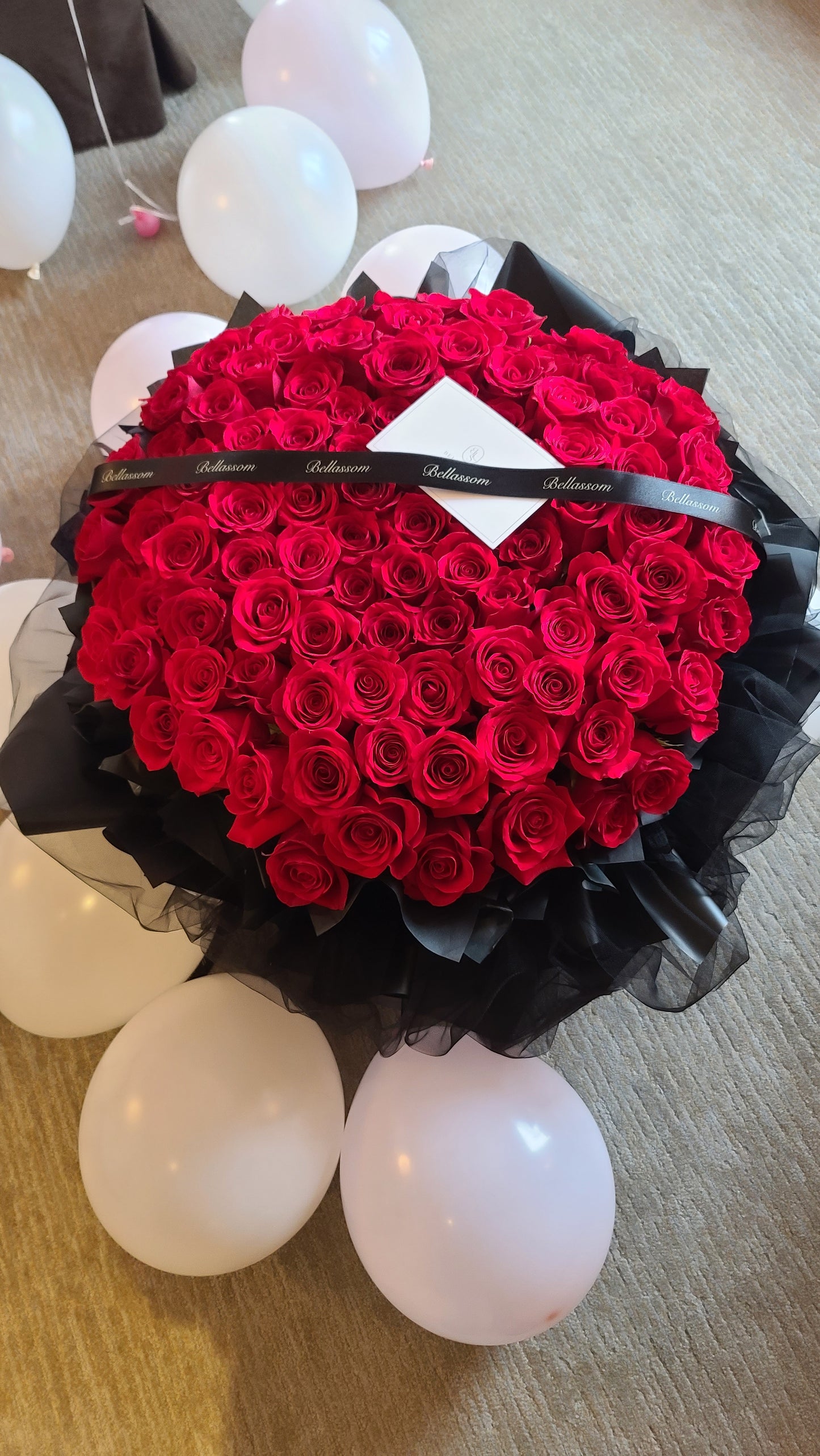 Top view of 100 Roses Luxury Bouquet showing premium roses and elegant crown & ribbon accessories, Vancouver delivery & pick-up available
