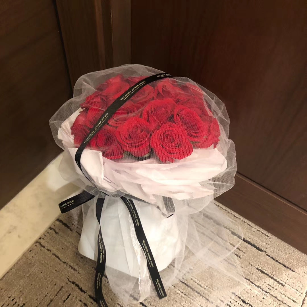 Bellassom's exclusive Veiled Rose bouquet with signature tulle fabric wrapping.